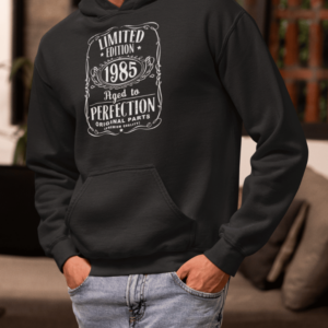 Black hoodie with “Limited Edition 1985 Aged to Perfection” white label design
